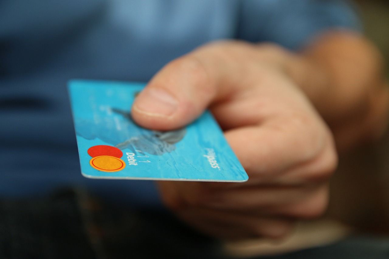 man offering credit card for use