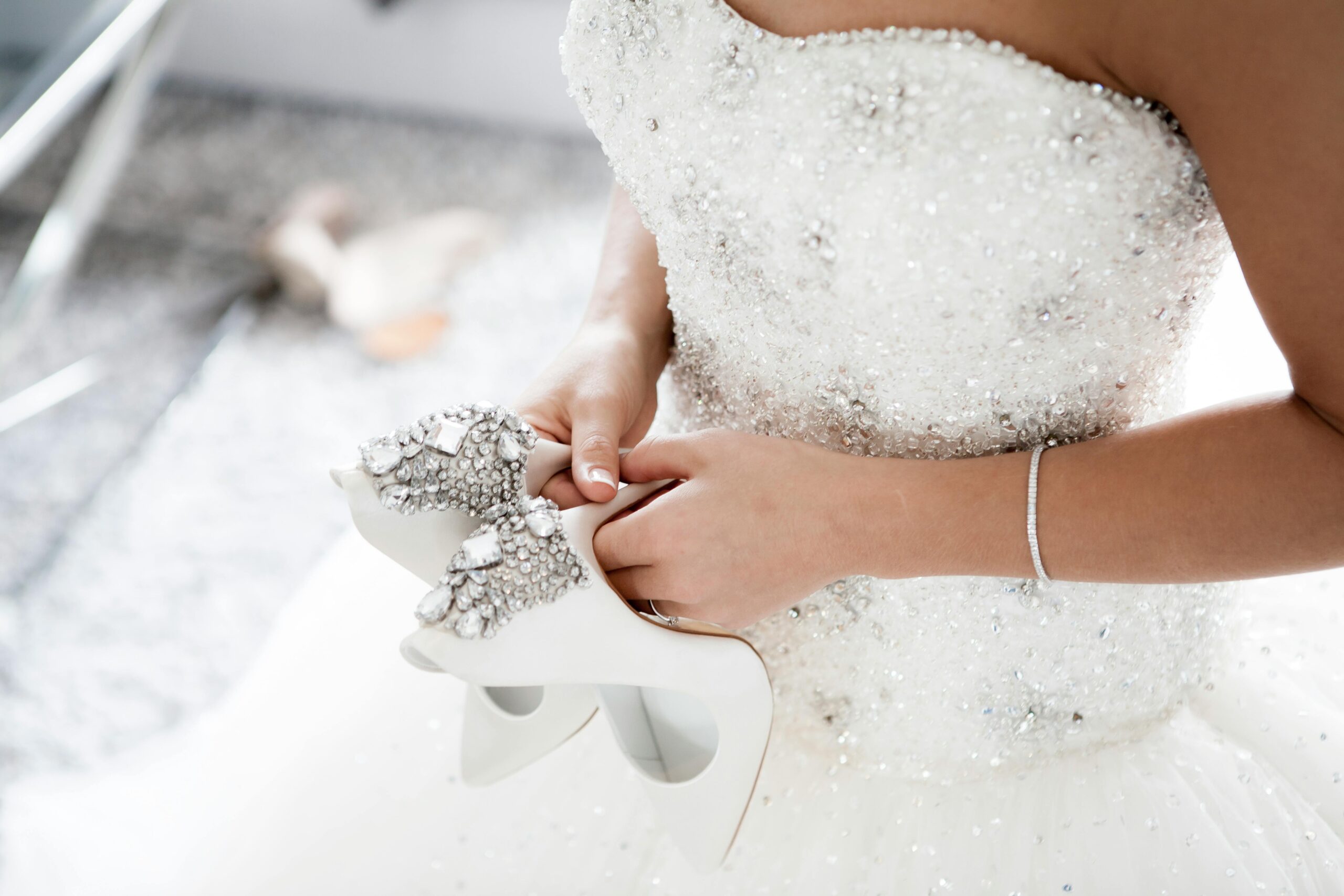 Bride holding her shoes during the big day